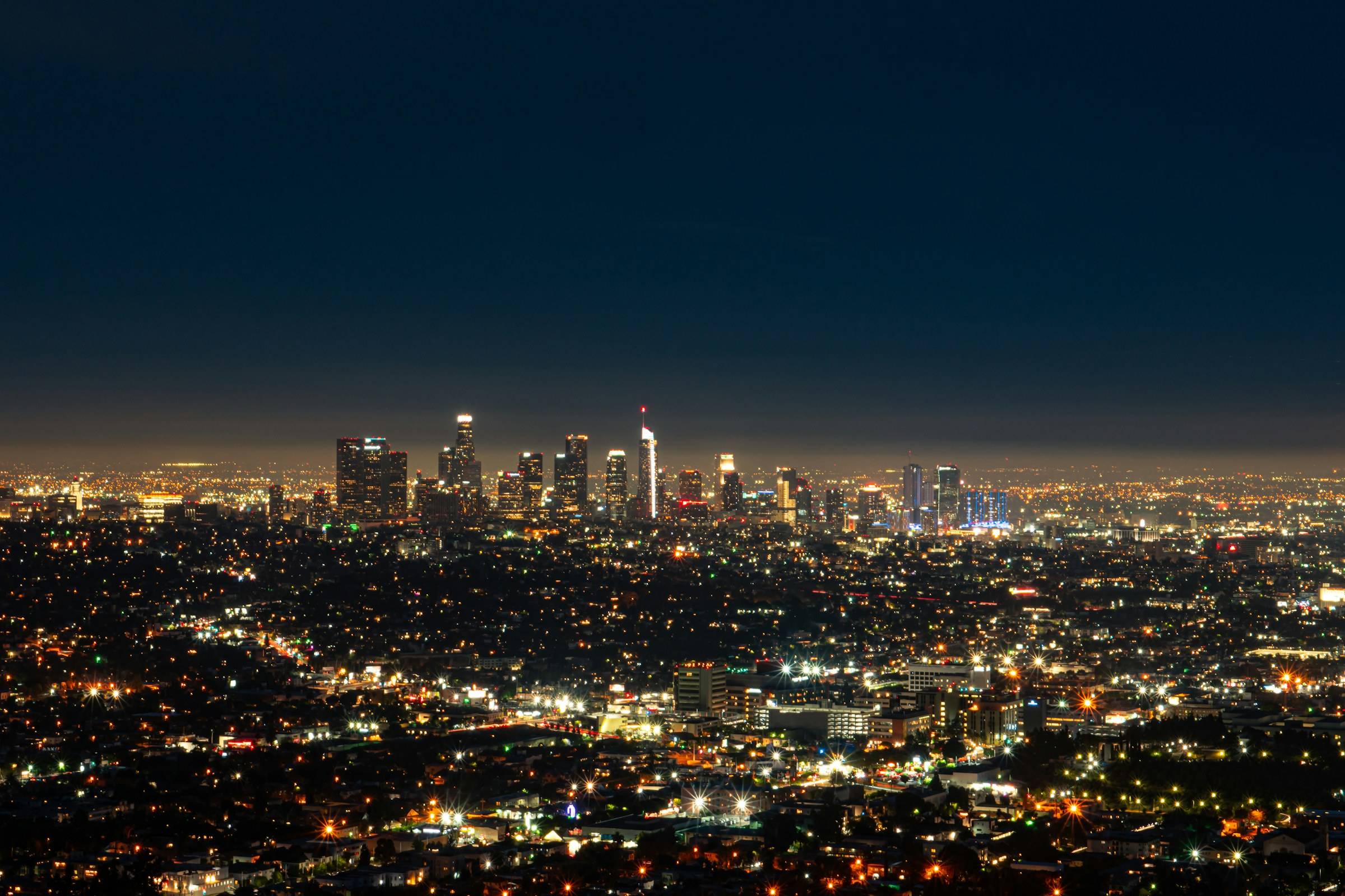 The lights of the Los Angeles basin at night, downtown towers on the horizon