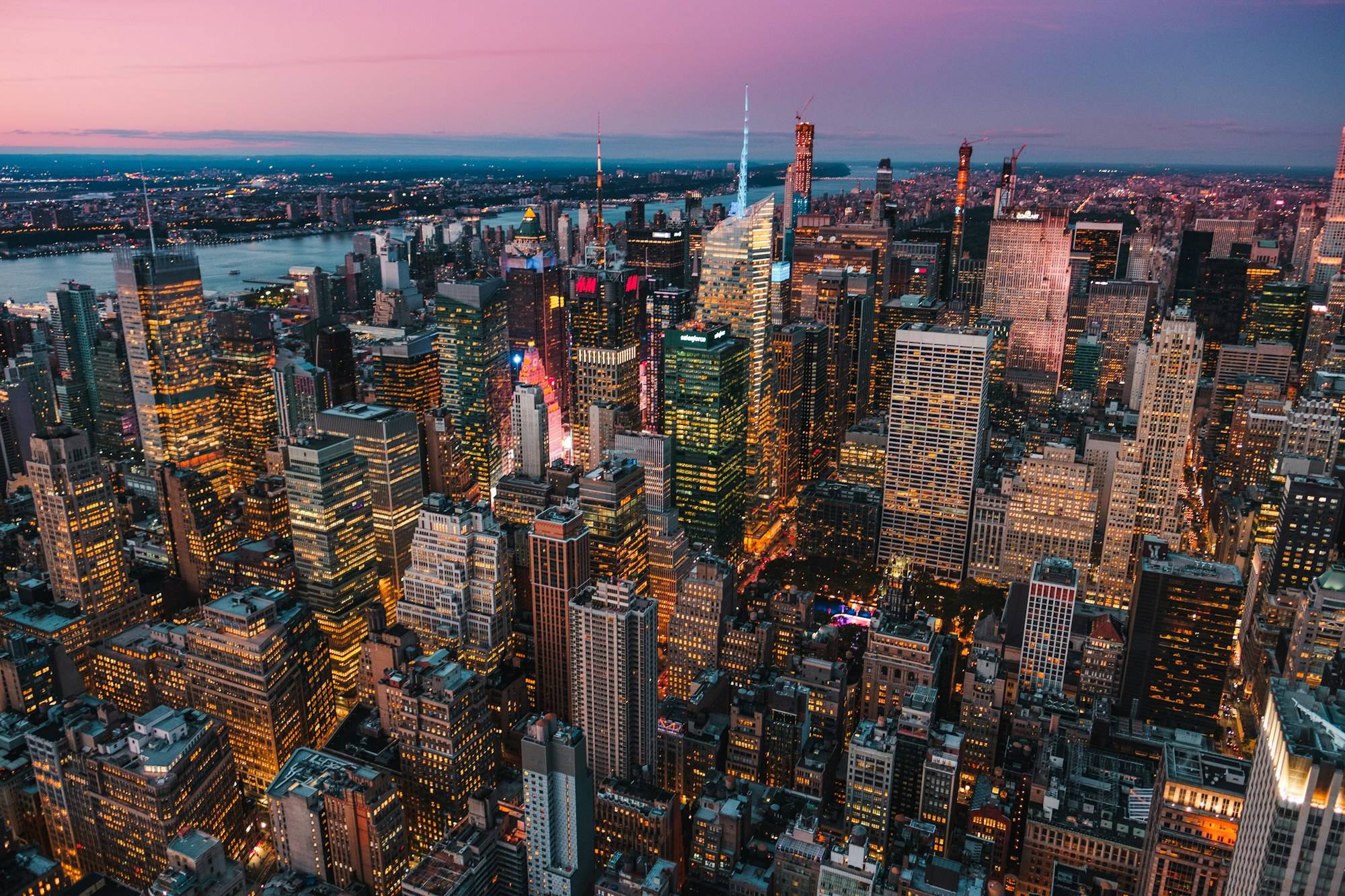 Aerial view of Midtown Manhattan at dusk with lights coming on