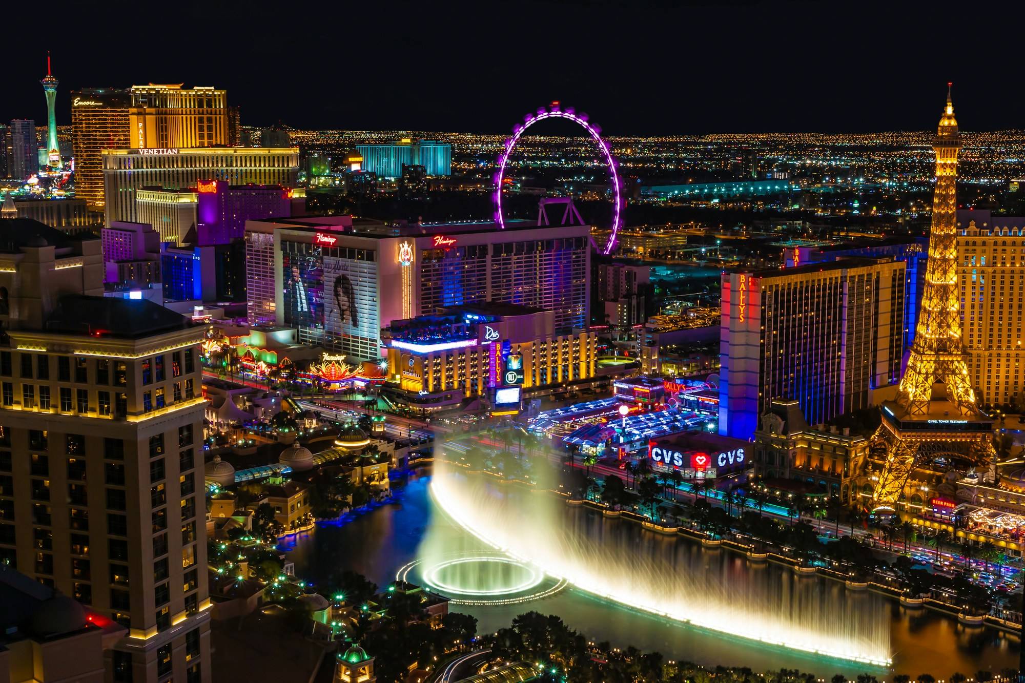 The Las Vegas Strip lit up at night, seen from above the Bellagio fountains